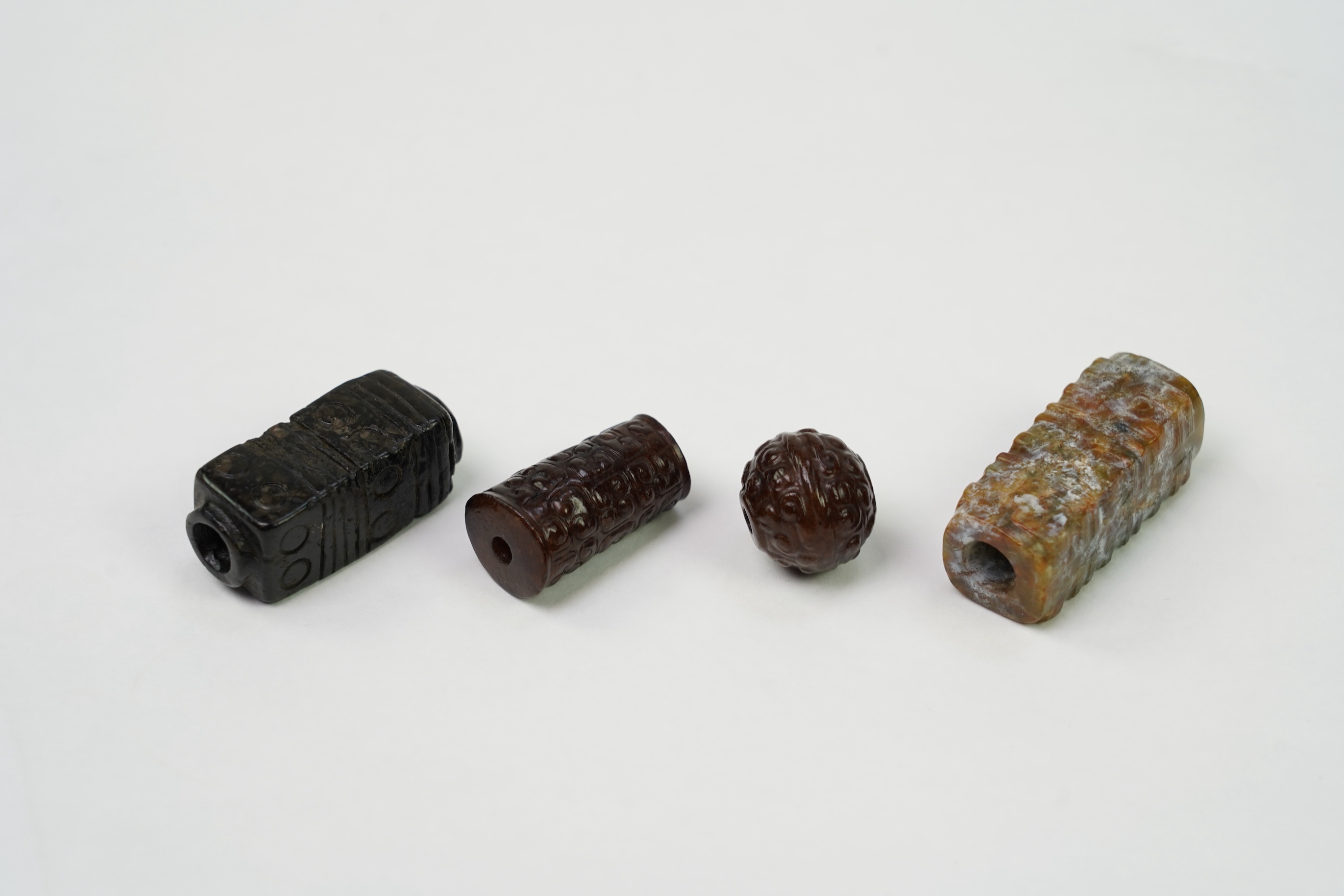 A group of four Chinese archaistic jade beads